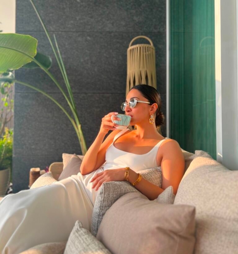 Kiara shared a photo in which she is seen drinking a cup of coffee in a stunning white outfit.